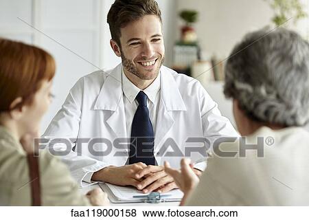 Stock Photo - Senior patient talking with doctor. Fotosearch