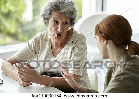 Senior patient talking with her daughter View Large Photo Image Picture - Senior patient talking with her daughter. Fotosearch