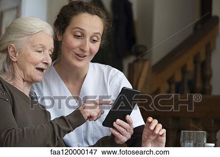 Senior patient using smartphone View Large Photo Image Stock Photo - Senior patient using smartphone. Fotosearch