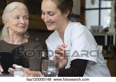 Senior patient using smartphone View Large Photo Image Stock Photo - Senior patient using smartphone. Fotosearch