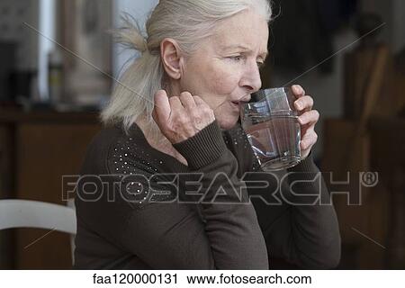 Stock Image - Senior woman drinking water. Fotosearch