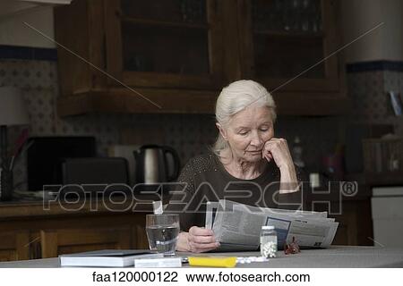 Senior woman reading newspaper View Large Photo Image Stock Image - Senior woman reading newspaper. Fotosearch
