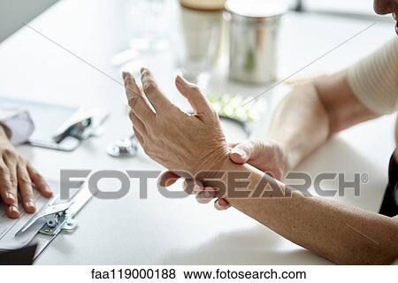 Senior woman showing her hand to doctor View Large Photo Image Stock Photo - Senior woman showing her hand to doctor. Fotosearch