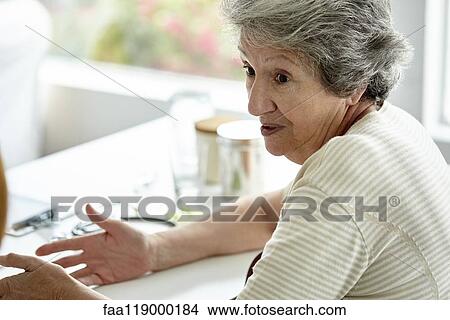 Senior woman sitting in clinic View Large Photo Image Picture - Senior woman sitting in clinic. Fotosearch