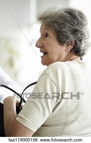 Senior woman sitting in the clinic View Large Photo Image Stock Photograph - Senior woman sitting in the clinic. Fotosearch