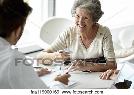 Senior woman talking with doctor in clinic View Large Photo Image Stock Photo - Senior woman talking with doctor in clinic. Fotosearch