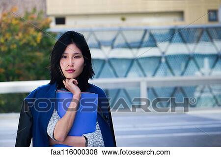 Serious woman holding file View Large Photo Image Stock Photo - Serious woman holding file. Fotosearch