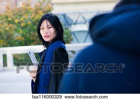 Serious woman holding file View Large Photo Image Stock Photo - Serious woman holding file. Fotosearch
