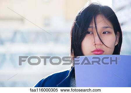 Serious woman holding file View Large Photo Image Stock Photography - Serious woman holding file. Fotosearch
