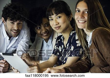 Stock Photography - Smiling business people sitting in office. Fotosearch