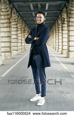 Smiling businessman standing at outdoors View Large Photo Image Picture - Smiling businessman standing at outdoors. Fotosearch