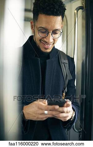 Smiling businessman using smartphone View Large Photo Image Stock Image - Smiling businessman using smartphone. Fotosearch