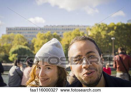 Stock Photo - Smiling couple standing outdoors. Fotosearch