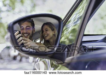 Smiling couple using smartphone View Large Photo Image Stock Image - Smiling couple using smartphone. Fotosearch