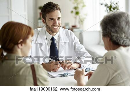 Smiling doctor talking with senior patient View Large Photo Image Stock Image - Smiling doctor talking with senior patient. Fotosearch