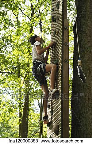 Teenage girl climbing on wall View Large Photo Image Stock Photo - Teenage girl climbing on wall. Fotosearch