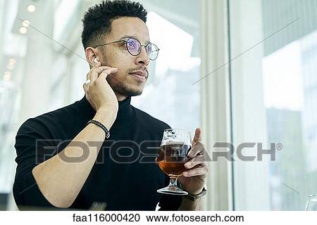 Thoughtful businessman having drink View Large Photo Image Stock Image - Thoughtful businessman having drink. Fotosearch