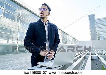 Stock Photo - Thoughtful businessman looking away. Fotosearch