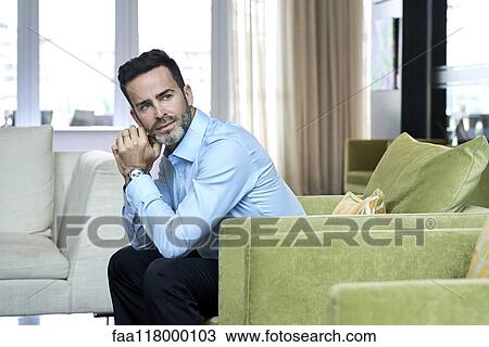 Thoughtful businessman sitting in hotel lobby View Large Photo Image Stock Image - Thoughtful businessman sitting in hotel lobby. Fotosearch