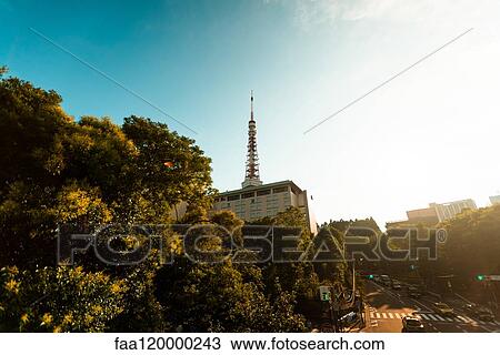 Stock Image - View of city street with Tokyo Tower. Fotosearch