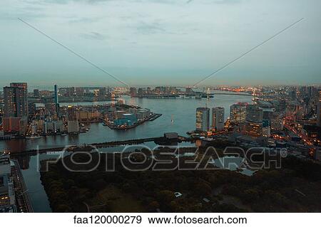 View of illuminated cityscape at dusk View Large Photo Image Stock Photo - View of illuminated cityscape at dusk. Fotosearch