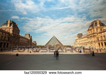 View of the Louvre Museum and the glass pyramid with tourists View Large Photo Image Stock Photo - View of the Louvre Museum and the glass pyramid with tourists. Fotosearch