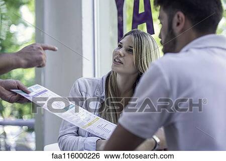 Stock Photograph - Waitress helping customer. Fotosearch