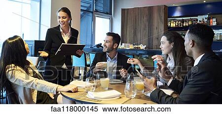 Waitress taking orders from business people in bar View Large Photo Image Stock Photography - Waitress taking orders from business people in bar. Fotosearch