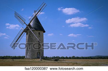 Stock Photo - Windmill on field. Fotosearch