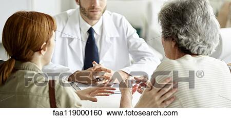 Woman and her daughter talking with doctor View Large Photo Image Stock Image - Woman and her daughter talking with doctor. Fotosearch