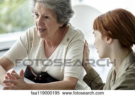 Woman comforting her mother View Large Photo Image Stock Photography - Woman comforting her mother. Fotosearch