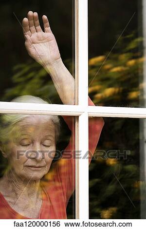 Woman looking through window View Large Photo Image Stock Photograph - Woman looking through window. Fotosearch