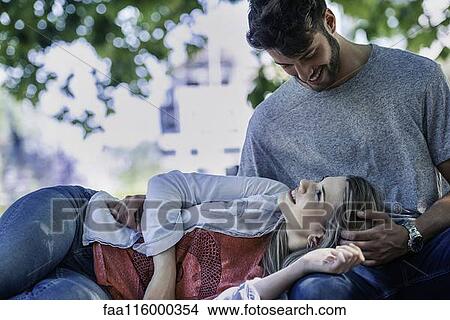 Woman relaxing on the man's lap View Large Photo Image Picture - Woman relaxing on the man's lap. Fotosearch