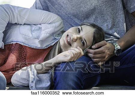 Woman relaxing on the man's lap View Large Photo Image Stock Image - Woman relaxing on the man's lap. Fotosearch