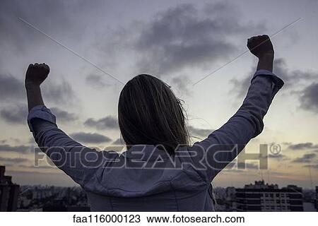 Woman stretching her hands while looking at cityscape View Large Photo Image Stock Image - Woman stretching her hands while looking at cityscape. Fotosearch