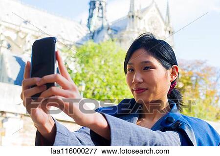 Woman taking selfie with smartphone View Large Photo Image Stock Photo - Woman taking selfie with smartphone. Fotosearch