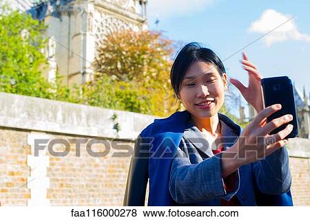 Woman taking selfie with smartphone View Large Photo Image Stock Photo - Woman taking selfie with smartphone. Fotosearch