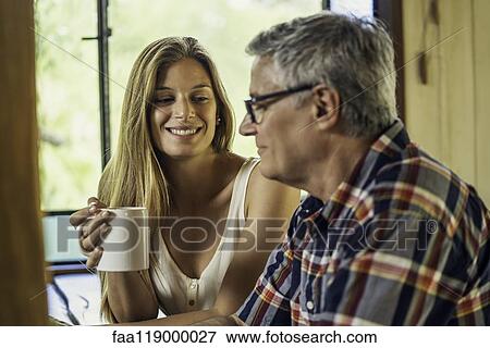 Woman talking with her father View Large Photo Image Stock Photo - Woman talking with her father. Fotosearch