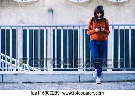 Woman using smartphone View Large Photo Image Stock Photo - Woman using smartphone. Fotosearch