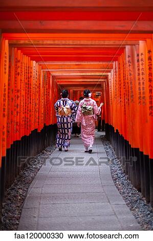 Women walking through Torii gates View Large Photo Image Stock Image - Women walking through Torii gates. Fotosearch