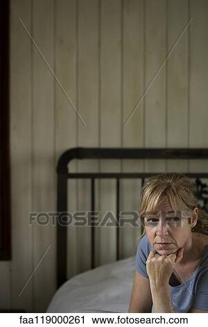 Worried woman sitting indoors View Large Photo Image Stock Image - Worried woman sitting indoors. Fotosearch