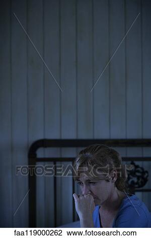 Worried woman sitting indoors View Large Photo Image Stock Image - Worried woman sitting indoors. Fotosearch