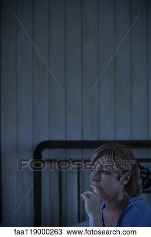 Worried woman sitting indoors View Large Photo Image Stock Image - Worried woman sitting indoors. Fotosearch