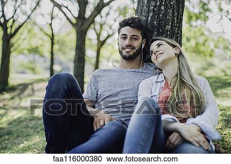 Young couple listening to music on headphones View Large Photo Image Stock Image - Young couple listening to music on headphones. Fotosearch