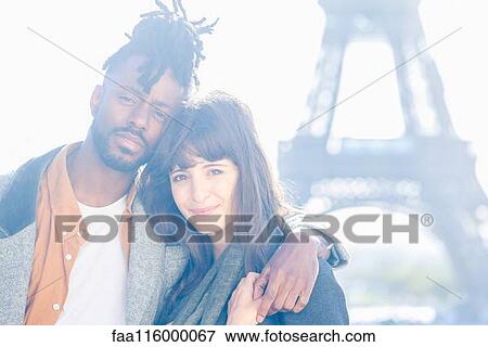 Young couple standing in front of Eiffel Tower View Large Photo Image Stock Photo - Young couple standing in front of Eiffel Tower. Fotosearch