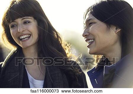 Young female friends smiling View Large Photo Image Stock Image - Young female friends smiling. Fotosearch
