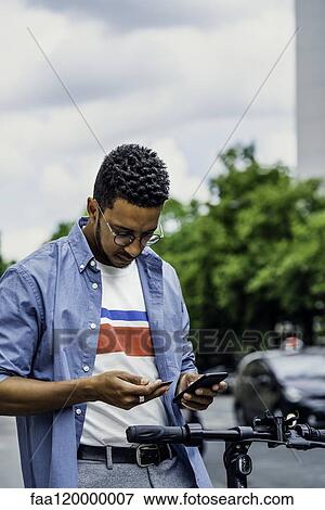 Young man making online payment with credit card View Large Photo Image Stock Photo - Young man making online payment with credit card. Fotosearch