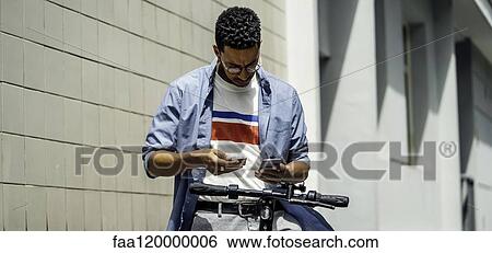 Stock Photograph - Young man making online payment with credit card. Fotosearch