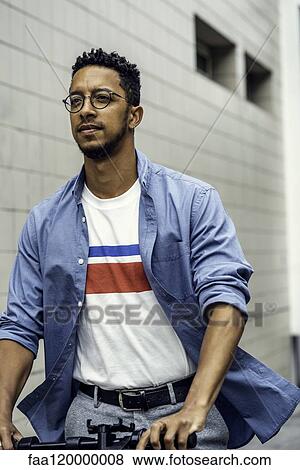 Stock Photo - Young man riding push scooter. Fotosearch