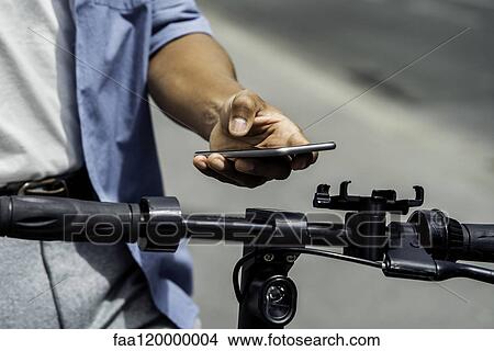 Young man using smart phone View Large Photo Image Picture - Young man using smart phone. Fotosearch